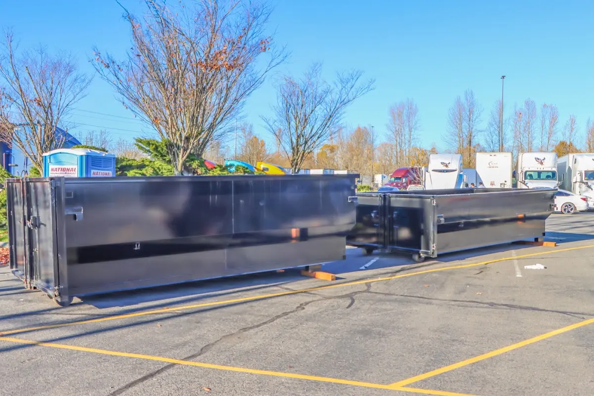 Professional dumpster rental service with roll-off container on residential driveway in Matthews